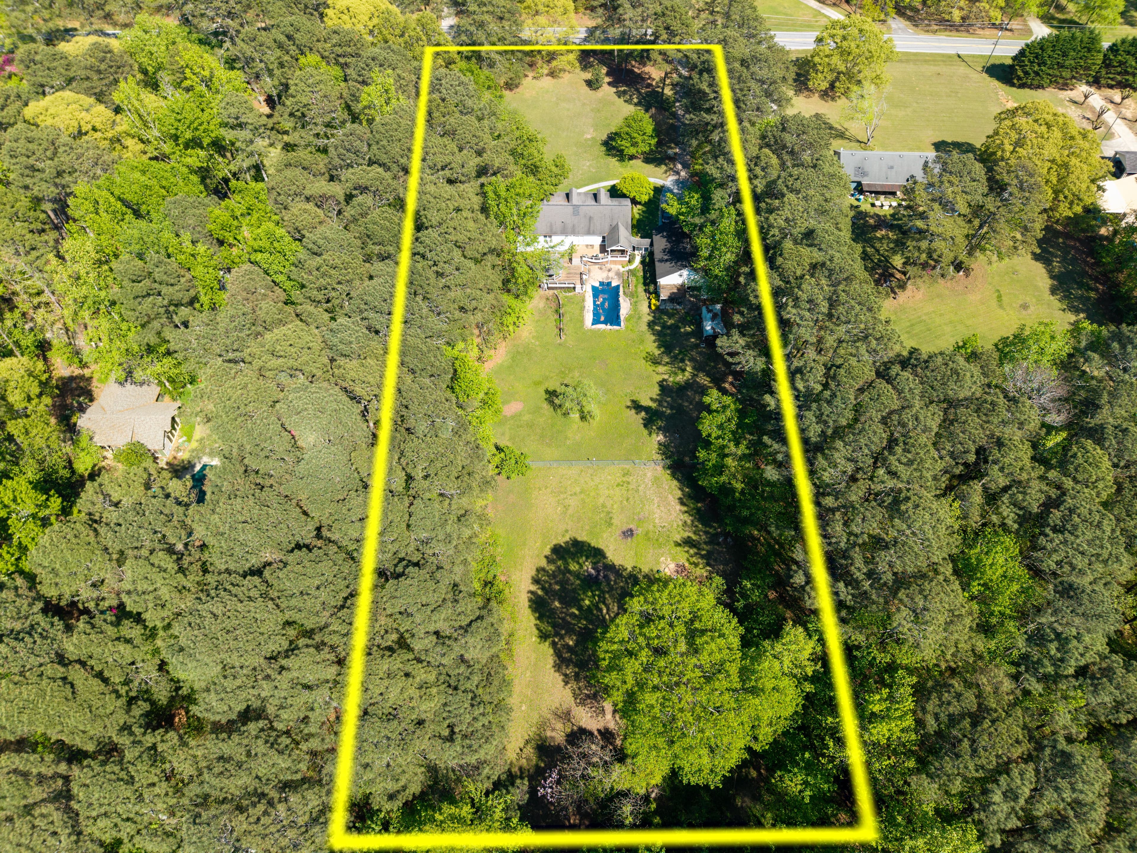 Second aerial property photo with a yellow outline showing lot boundaries from another angle